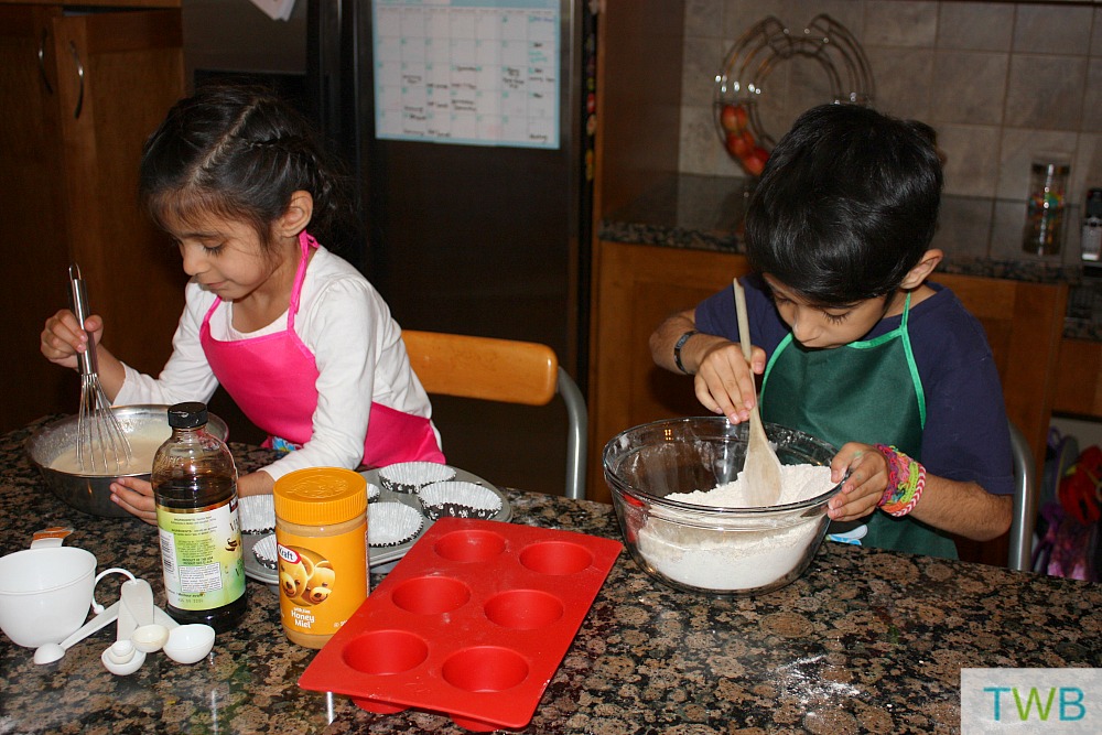 Kids hard at work mixing the wet and dry ingredients